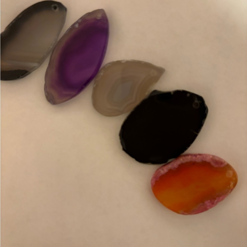 Various cut stones with holes already in them so you can make a pendant